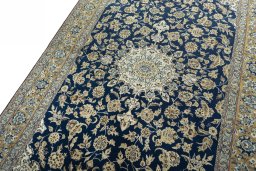 Backside of handmade 1950s Ghom rug showing knot structure and weave density