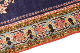 Backside of handmade 2001s Ghom rug showing knot structure and weave density