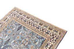 Surface texture of 1999s Ghom rug with natural Wool and intricate pattern