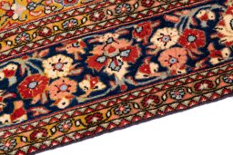 Backside of handmade 1972s Ghom rug showing knot structure and weave density
