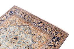 Surface texture of 1975s Ghom rug with natural Wool and intricate pattern