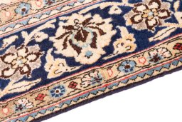Backside of handmade 1975s Ghom rug showing knot structure and weave density