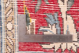 Corner detail of 1985s Ghom rug showing border pattern and Wool pile