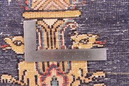 Corner detail of 1995s Ghom rug showing border pattern and Wool pile