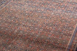 Surface texture of 2000s Hoseinabad rug with natural Wool and intricate pattern