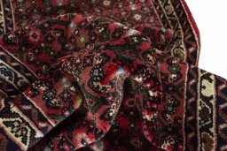 Corner detail of New Hoseinabad rug showing border pattern and Wool pile