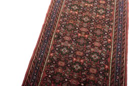 Backside of handmade New Hoseinabad rug showing knot structure and weave density