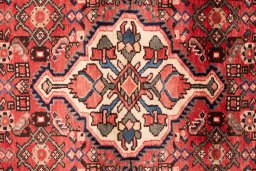 Full view of 1972s Hoseinabad rug from Iran / Persia, 340 × 115 cm in Red tones