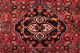 Full view of 1970s Hoseinabad rug from Iran / Persia, 200 × 140 cm in Red tones