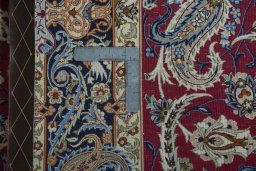 Backside of handmade 2000s Isfahan rug showing knot structure and weave density