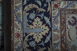 Backside of handmade New Isfahan rug showing knot structure and weave density