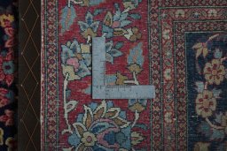 Backside of handmade 1930s Isfahan rug showing knot structure and weave density