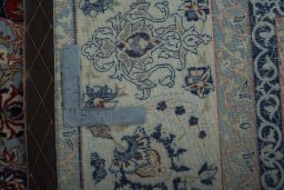Backside of handmade 1970s Isfahan rug showing knot structure and weave density
