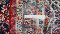 Corner detail of New Kashan rug showing border pattern and Wool pile