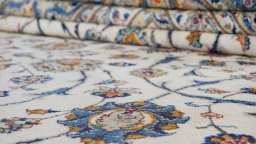 Corner detail of New Kashan rug showing border pattern and Wool pile
