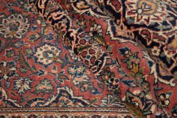 Corner detail of New Kashan rug showing border pattern and Wool pile