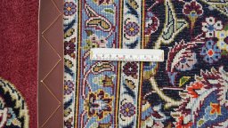 Corner detail of 1990s Kashan rug showing border pattern and Wool pile