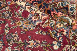 Corner detail of 1950s Kashan rug showing border pattern and Wool pile