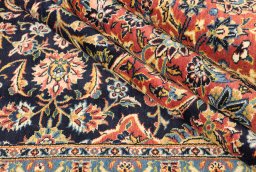 Corner detail of New Kashan rug showing border pattern and Wool pile