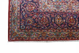 Backside of handmade 2000s Kashan rug showing knot structure and weave density