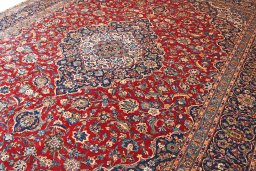 Corner detail of 2000s Kashan rug showing border pattern and Wool pile