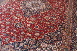 Backside of handmade 2000s Kashan rug showing knot structure and weave density