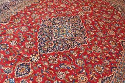 Corner detail of 2000s Kashan rug showing border pattern and Wool pile