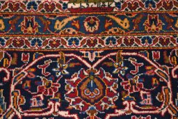 Backside of handmade 2000s Kashan rug showing knot structure and weave density