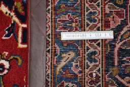 Corner detail of 2000s Kashan rug showing border pattern and Wool pile