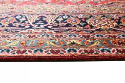 Corner detail of 2000s Kashan rug showing border pattern and Wool pile