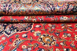 Backside of handmade 2000s Kashan rug showing knot structure and weave density