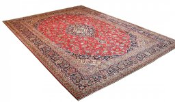 Corner detail of 2000s Kashan rug showing border pattern and Wool pile