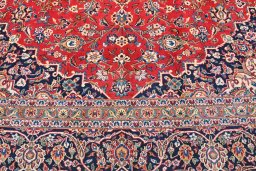 Backside of handmade 2000s Kashan rug showing knot structure and weave density