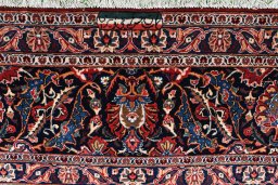 Corner detail of 1930s Kashan rug showing border pattern and Wool pile