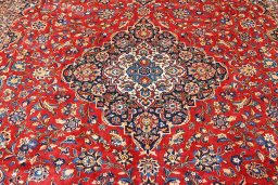 Corner detail of 2000s Kashan rug showing border pattern and Wool pile