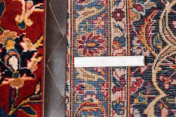 Corner detail of 2000s Kashan rug showing border pattern and Wool pile