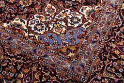 Corner detail of 2000s Kashan rug showing border pattern and Wool pile