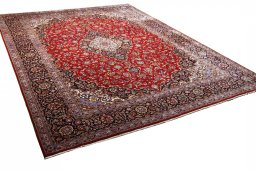 Corner detail of 2000s Kashan rug showing border pattern and Wool pile