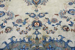 Backside of handmade 2000s Kashan rug showing knot structure and weave density