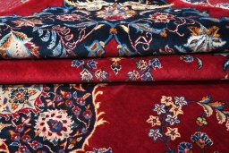 Corner detail of 2000s Kashan rug showing border pattern and Wool pile
