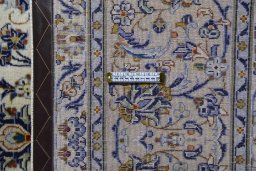 Corner detail of 2000s Kashan rug showing border pattern and Wool pile
