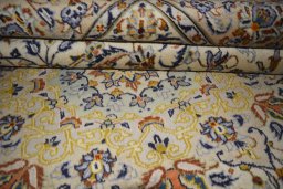 Close-up detail of 2000s Kashan rug from Iran / Persia showing Wool weave