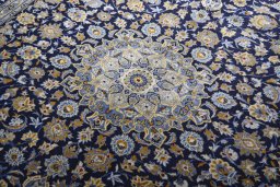 Backside of handmade 2000s Kashan rug showing knot structure and weave density