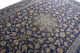 Backside of handmade 2000s Kashan rug showing knot structure and weave density