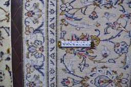 Corner detail of 2000s Kashan rug showing border pattern and Wool pile