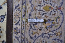Corner detail of 2000s Kashan rug showing border pattern and Wool pile