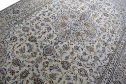 Backside of handmade 2000s Kashan rug showing knot structure and weave density