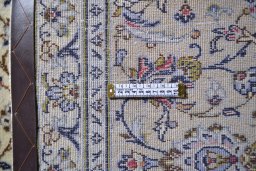 Corner detail of 2000s Kashan rug showing border pattern and Wool pile