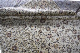 Corner detail of 2000s Kashan rug showing border pattern and Wool pile