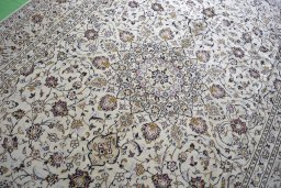 Backside of handmade 2000s Kashan rug showing knot structure and weave density
